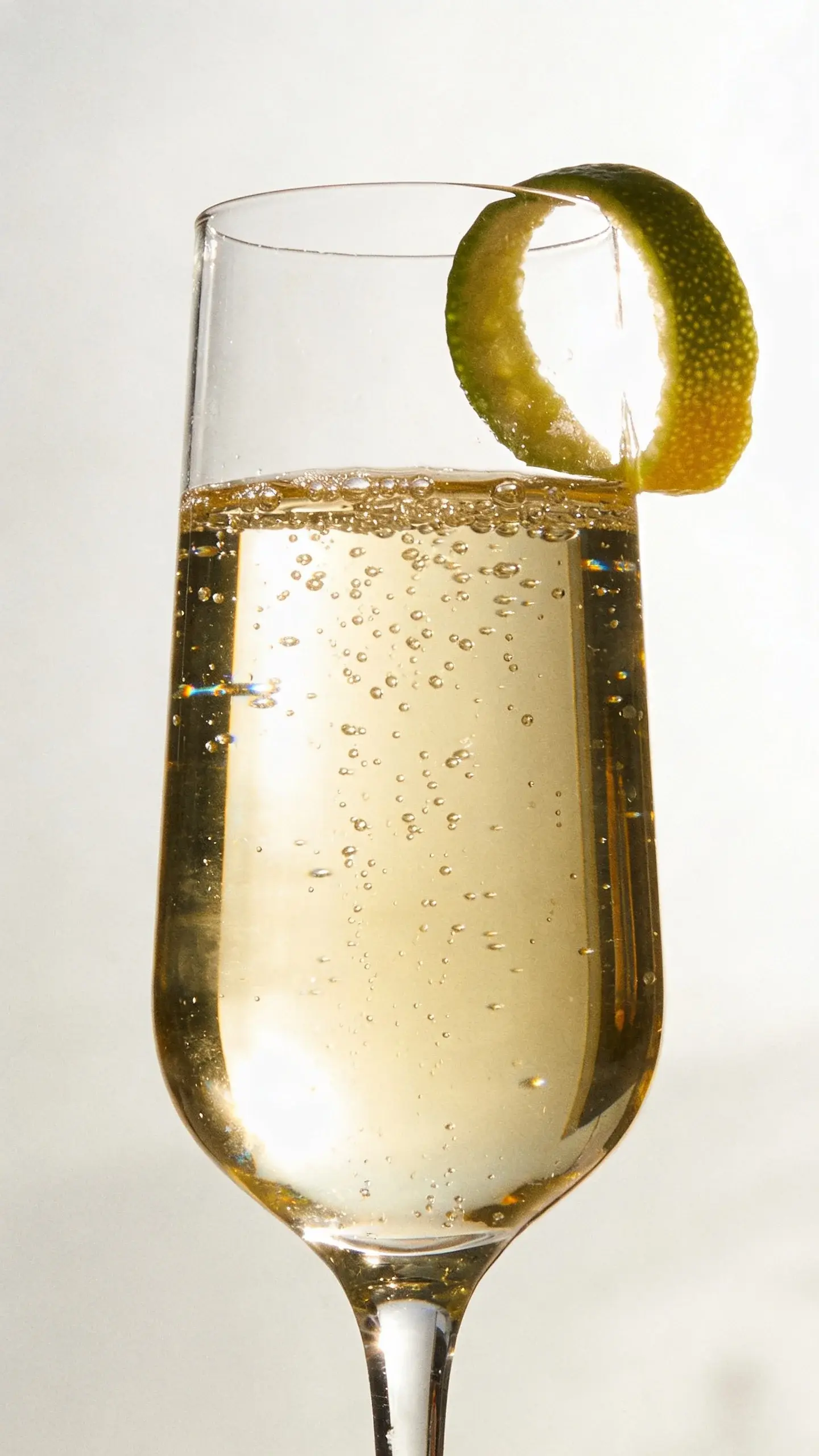 Sparkling mocktail with citrus twist, soft backlight, minimalist setting