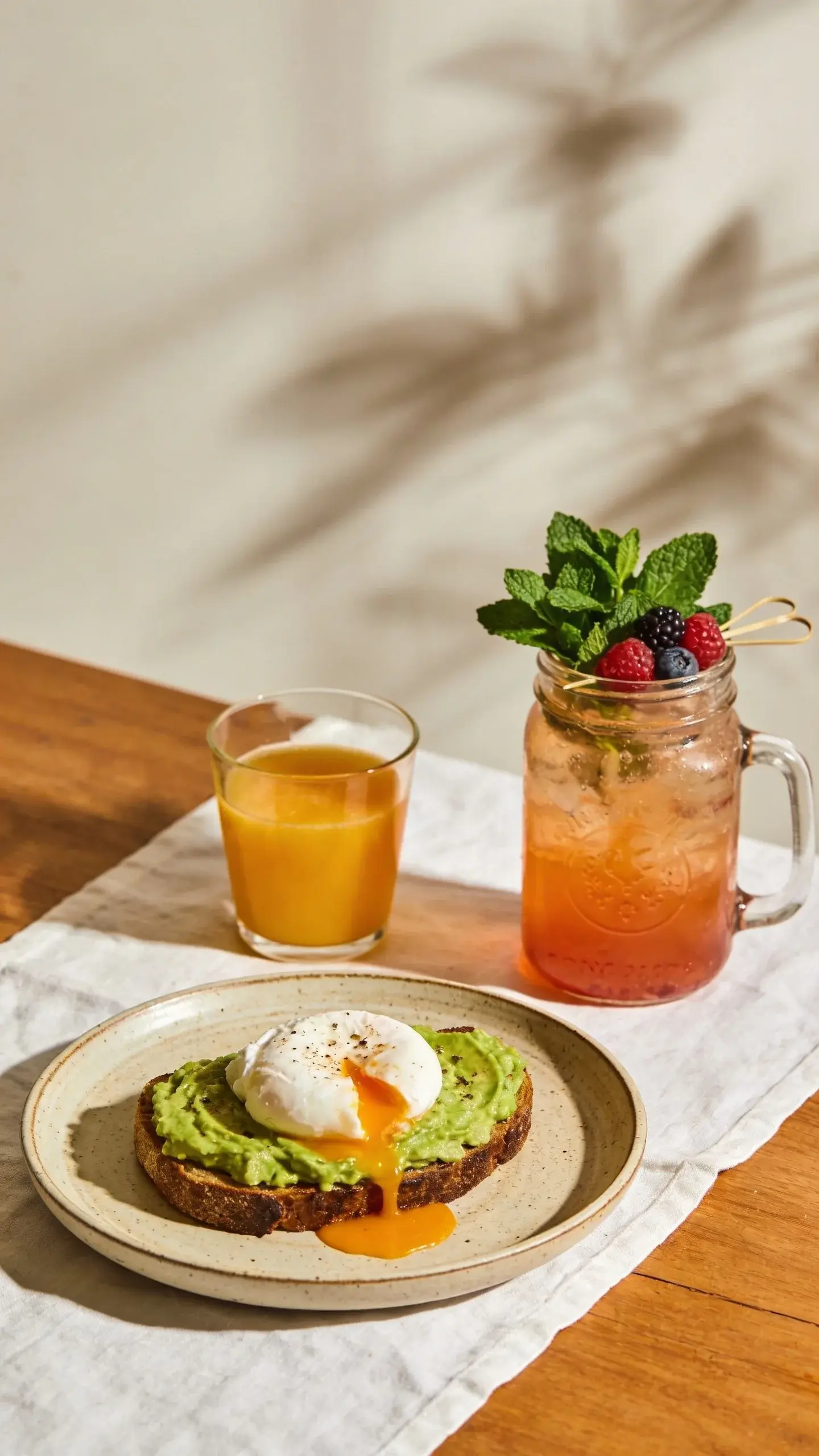 Brunch setting: light shadows, mason jar mocktail bouquet garnish